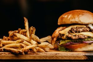 Burger and Fries in Front of Black Backdrop