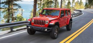 Red 2021 Jeep Wrangler Driving Down a Road